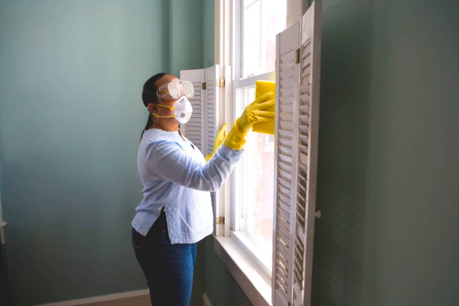 woman cleaning window frame