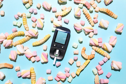 Glucometer surrounded by candy