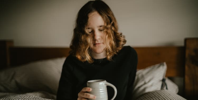woman with coffee in bed